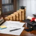 PhD journey visual with books, diploma, research papers, and graduation cap on desk — symbolizing doctoral milestones and academic progression.