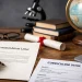 Professional academic desk scene showing a PhD recommendation letter, CV, books, globe, and laptop representing references for a PhD application with ScholarLink watermark.