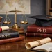 Academic desk scene illustrating the MPhil and PhD research path, with thesis books, graduation cap, and research symbols representing the Master of Philosophy degree.