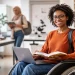 Accessible PhD study with a disability — doctoral student using a wheelchair working on a laptop in a modern university research environment with inclusive academic support.