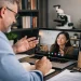 Online PhD interview between a professor and international student via video call, showcasing a professional virtual doctoral interview setup with modern academic environment and ScholarLink watermark